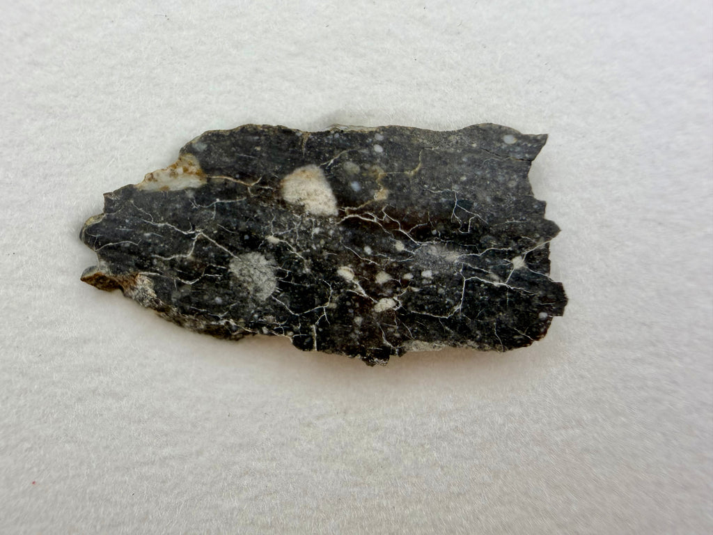 Rabt Sbayta 007 lunar meteorite 1.44g -- feldspathic breccia texture showing light-toned highland crustal material
