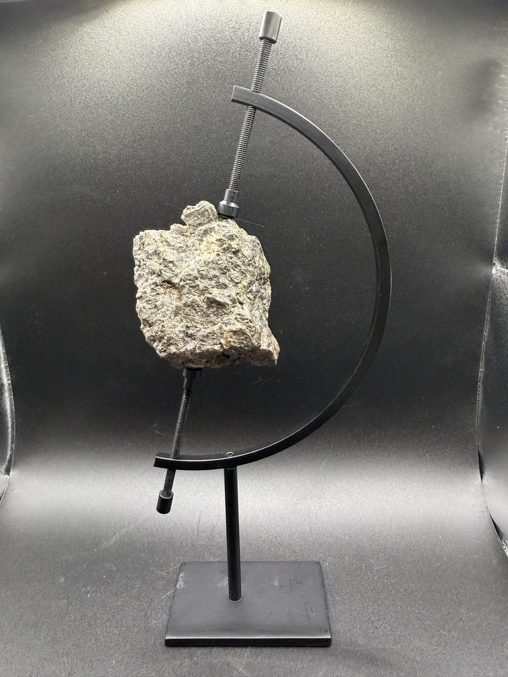Laâyoune 002 lunar meteorite individual, 193.73g, on a display stand