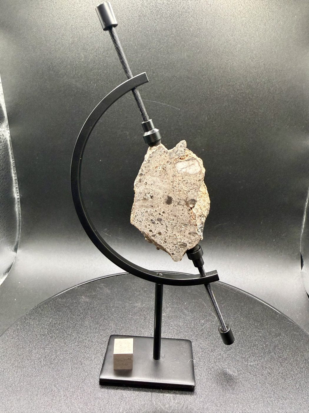 NEA 089 lunar meteorite, larger half on a display stand, polished face forward