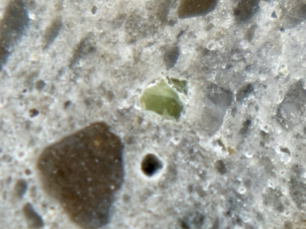 Olivine grain in the mirror polished face of NEA 089 lunar meteorite, macro view