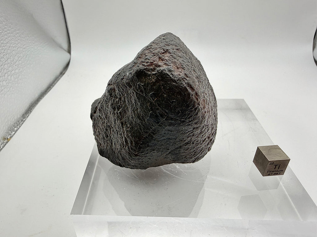NWA XXX chondrite 316.40g -- fresh black fusion crust surface with flow lines documenting atmospheric flight trajectory