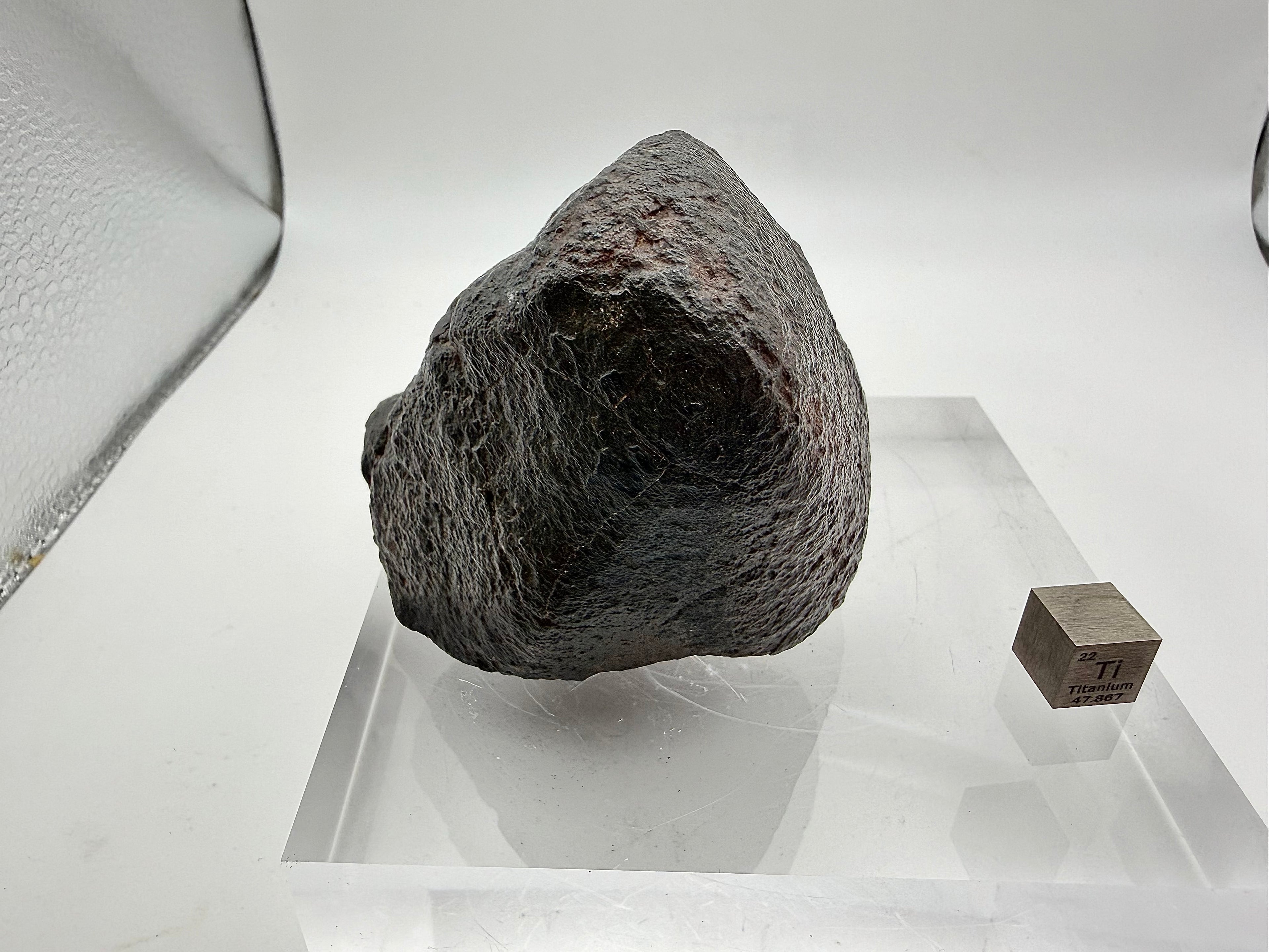 NWA XXX chondrite 316.40g -- fresh black fusion crust surface with flow lines documenting atmospheric flight trajectory