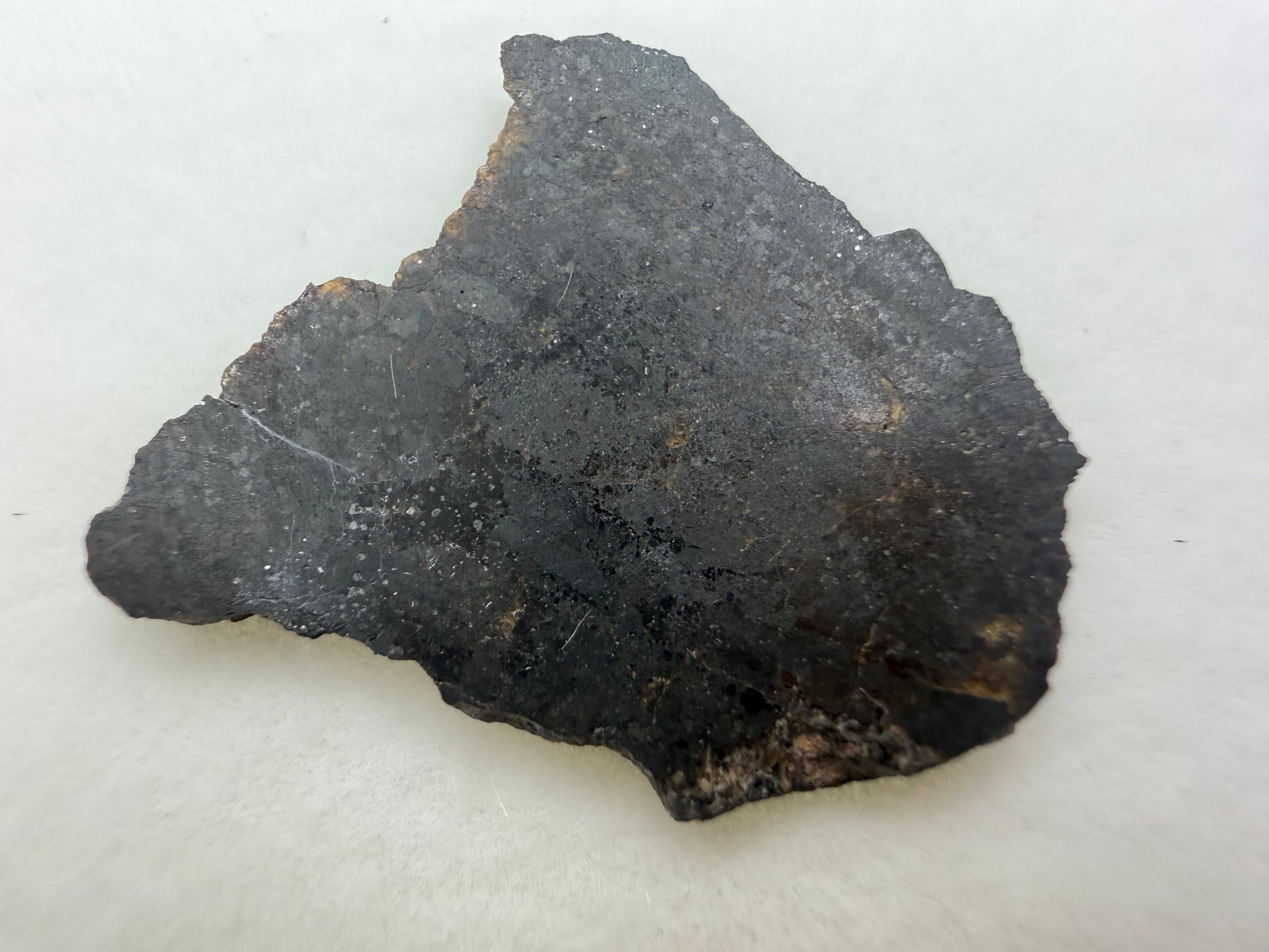 Rafsa 005 angrite 1.00g -- dark matrix showing characteristic dense plutonic texture from slow subsurface cooling