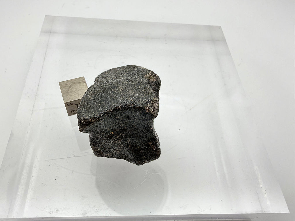 Guemar 002 Moon rock 45.92g -- fusion crust detail showing smooth glassy veneer over primary igneous structure