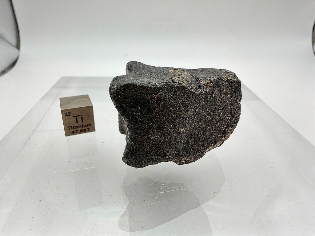 Guemar 002 Moon meteorite 45.92g -- contrast between black fusion veneer and dark gray basaltic interior composition