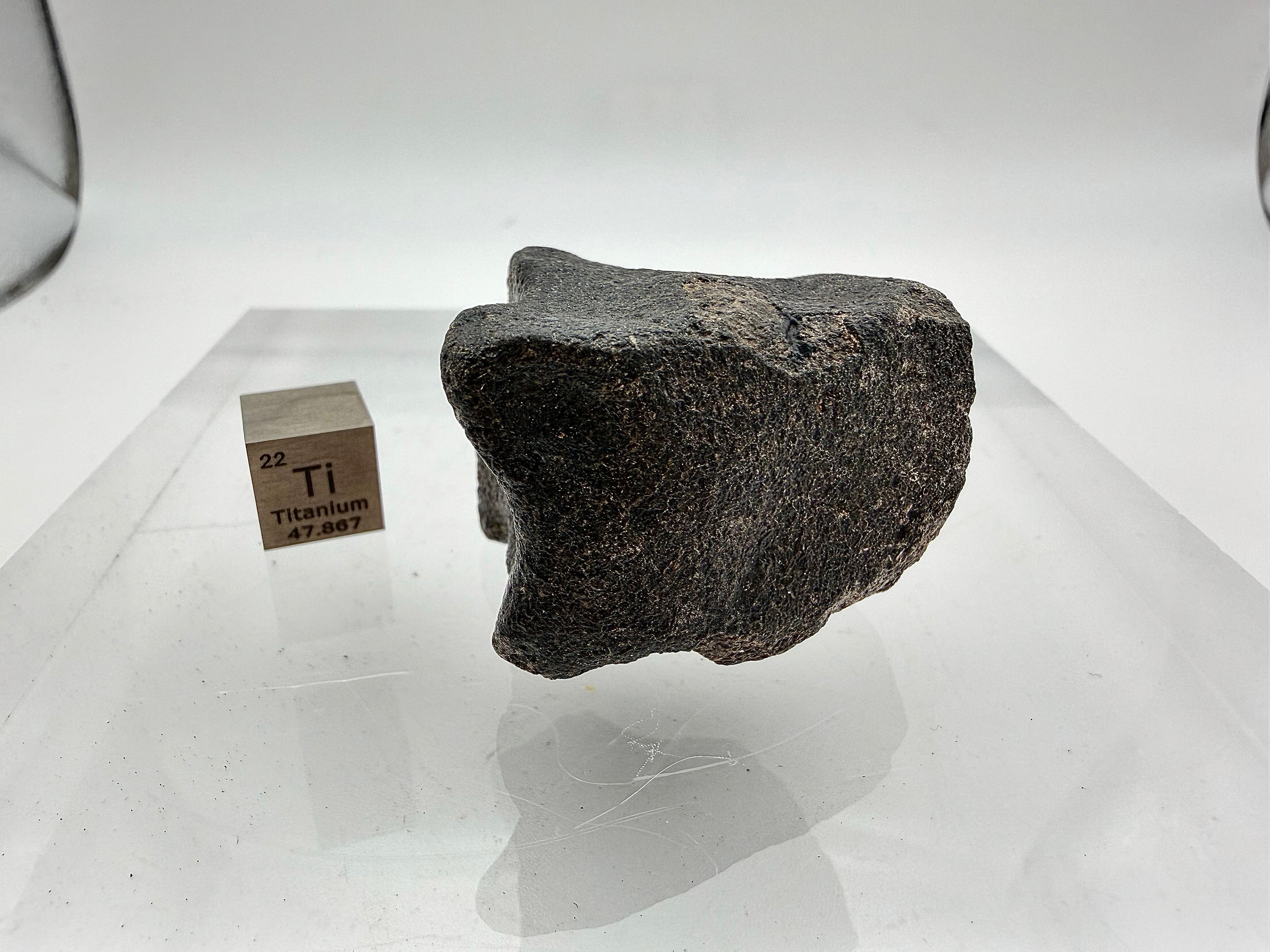 Guemar 002 Moon meteorite 45.92g -- contrast between black fusion veneer and dark gray basaltic interior composition