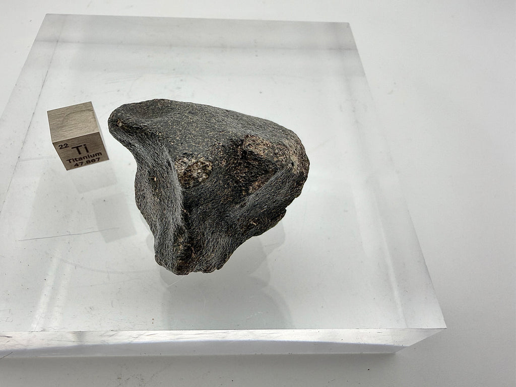 Guemar 002 lunar meteorite 45.92g -- intact fusion crust coverage showing glassy black surface from atmospheric entry