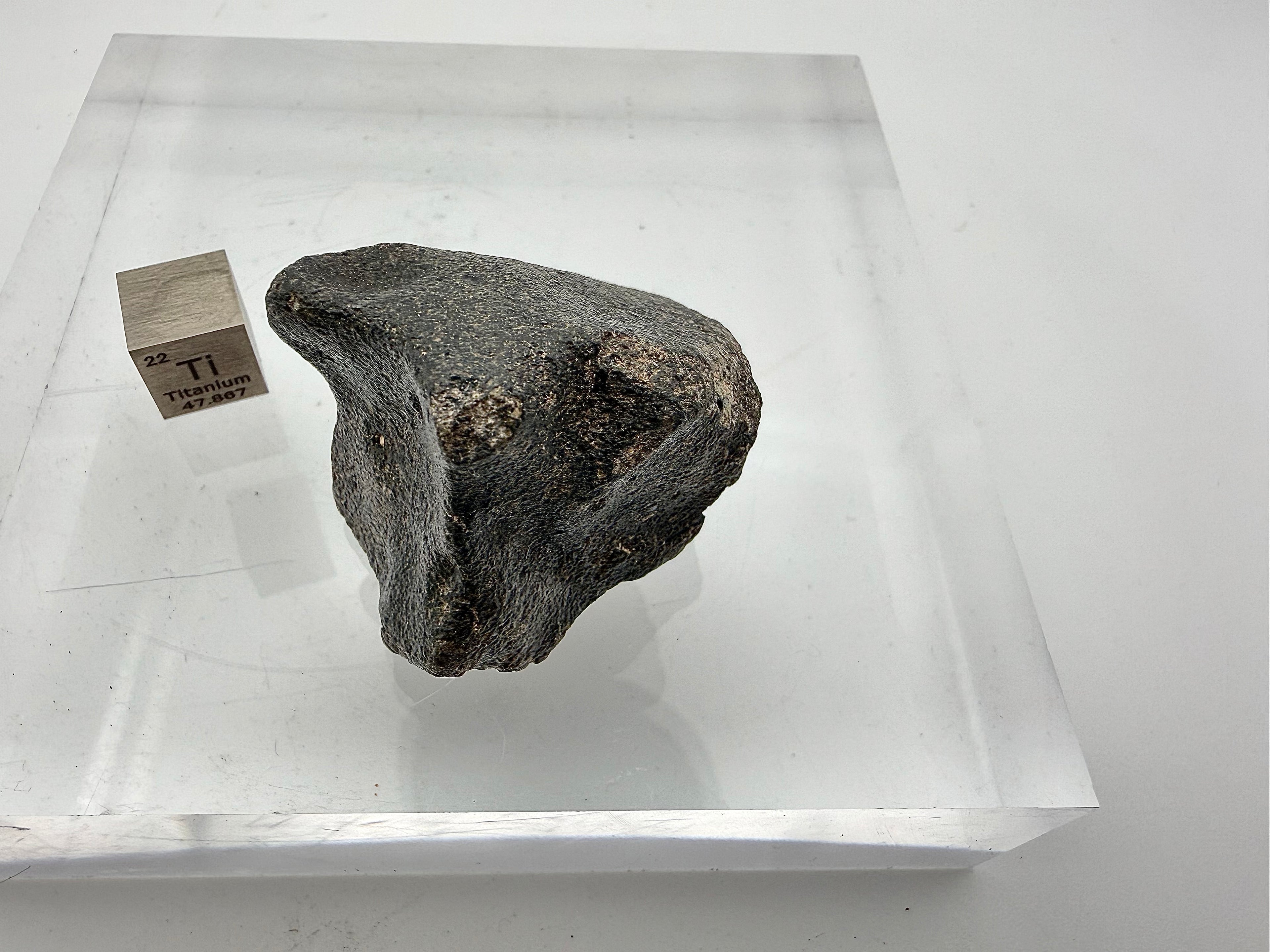 side view of moon rock with scale cube