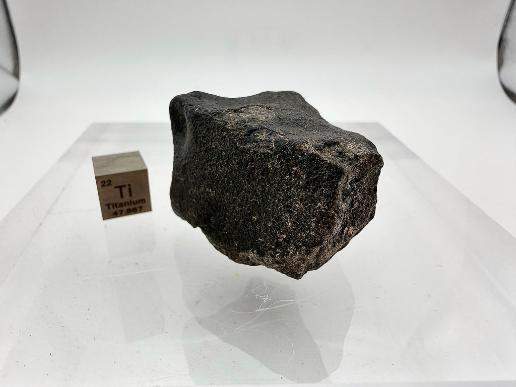 Guemar 002 lunar specimen 45.92g -- fusion crust texture with flow lines from hypersonic atmospheric passage
