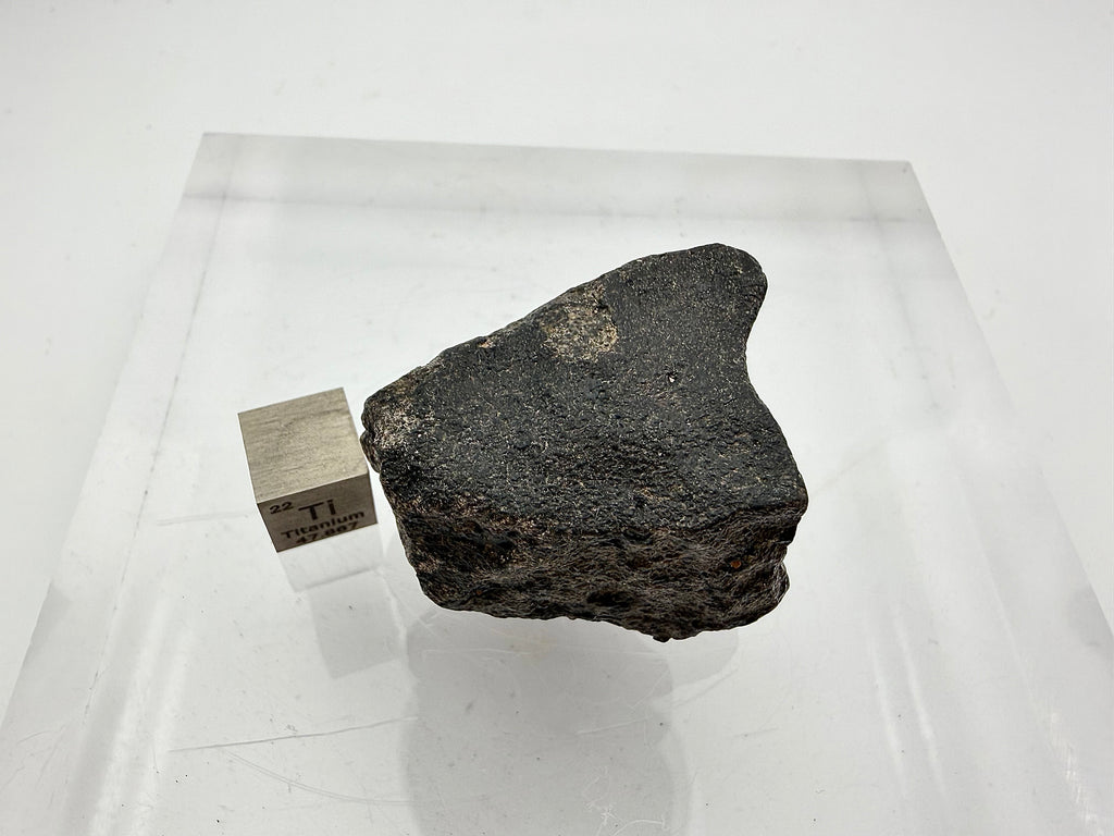 Guemar 002 unbrecciated lunar meteorite 45.92g -- complete individual profile view with intact atmospheric ablation crust