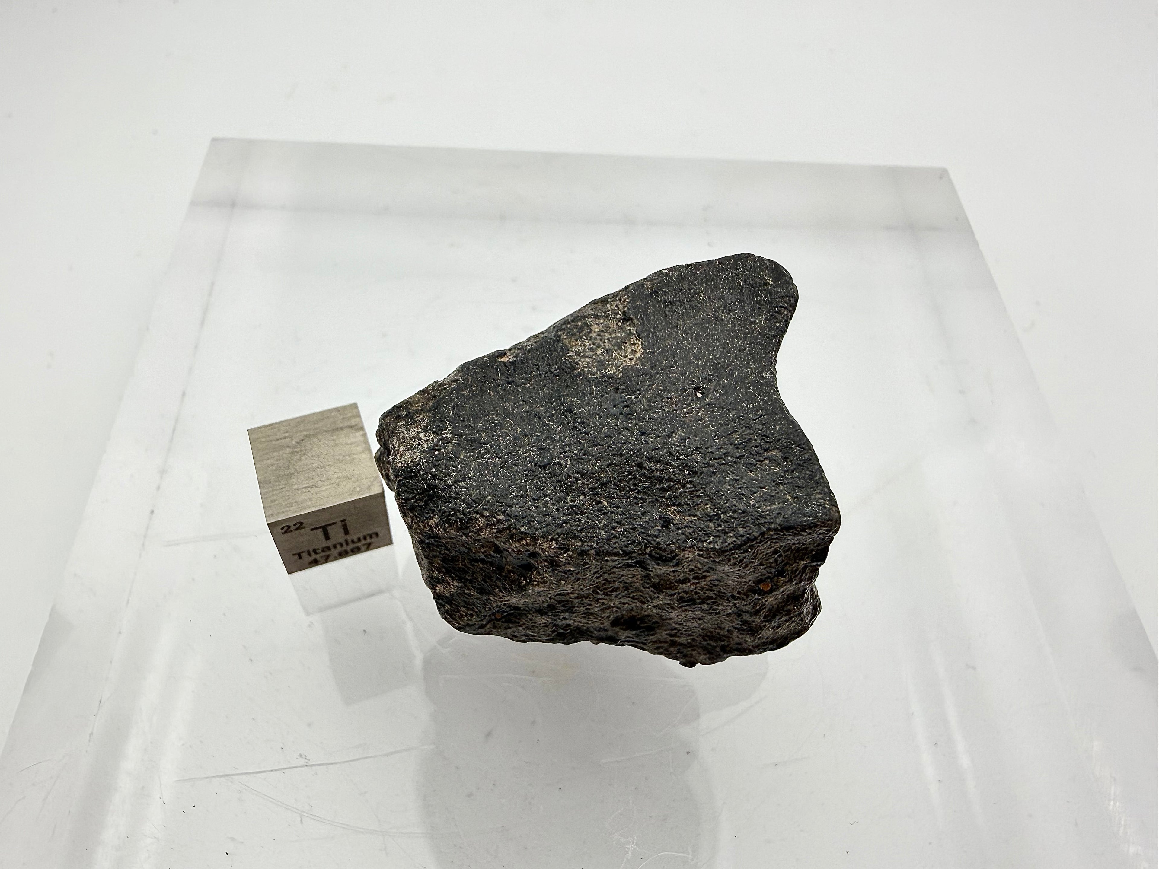 Guemar 002 unbrecciated lunar meteorite 45.92g -- complete individual profile view with intact atmospheric ablation crust