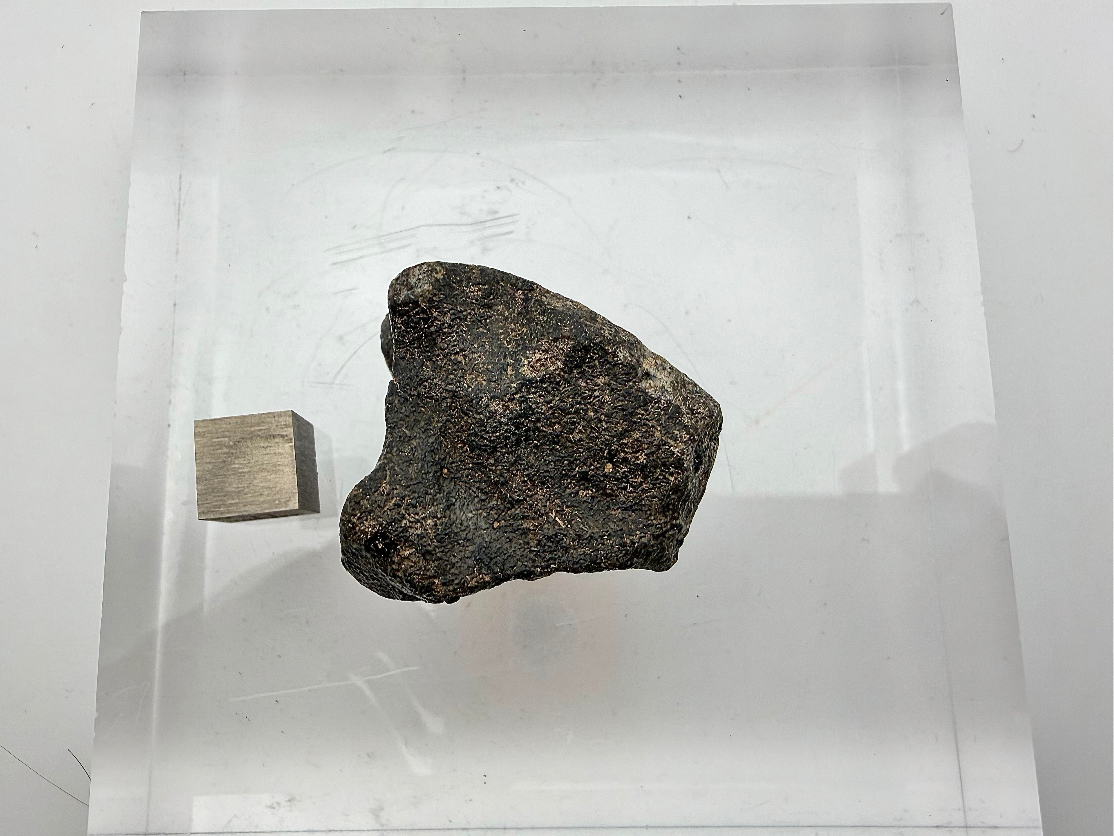 backside view of lunar rock with scale cube