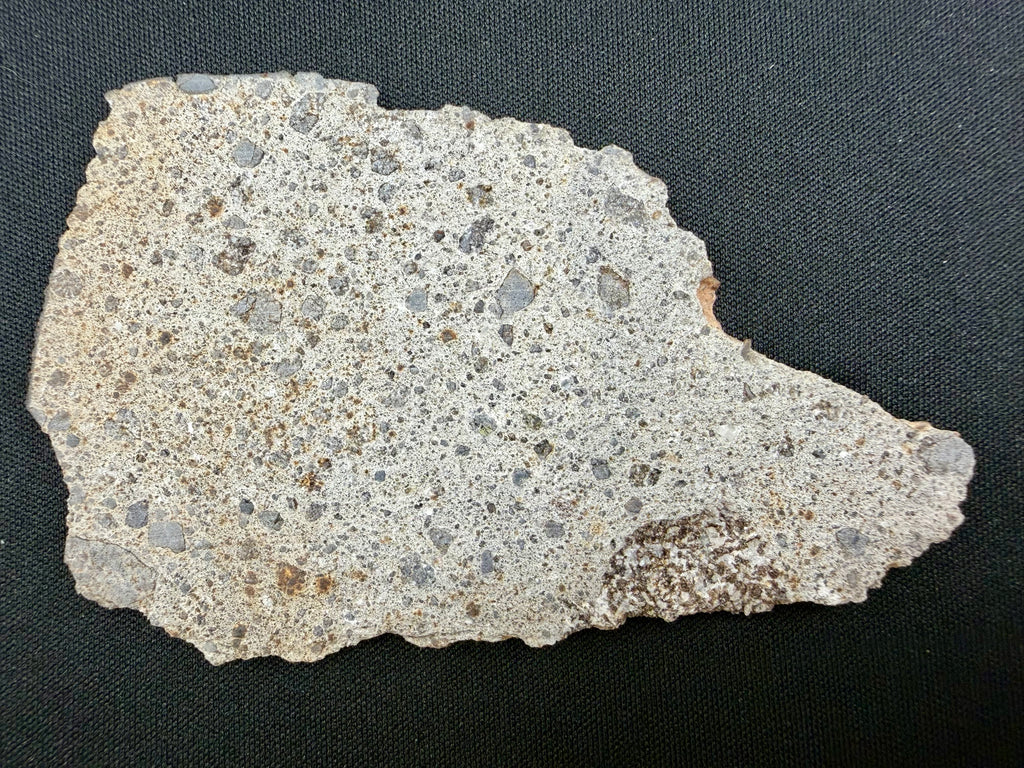NWA 17708 howardite 26.23g -- rippled fusion crust texture along edge surface showing atmospheric entry heating patterns