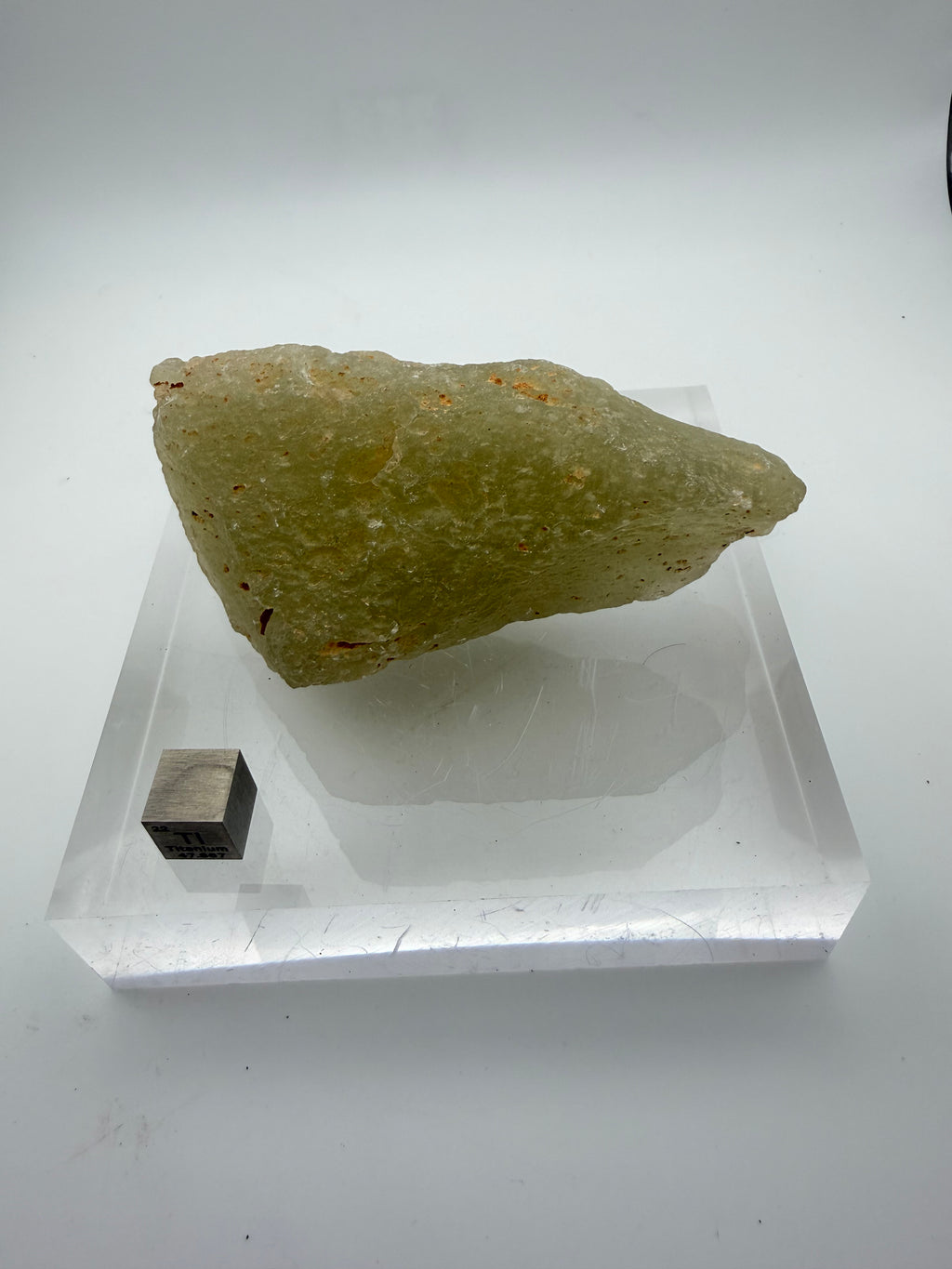Libyan Desert Glass 178.68g -- translucent yellow-green coloration showing natural flow textures from impact melt event