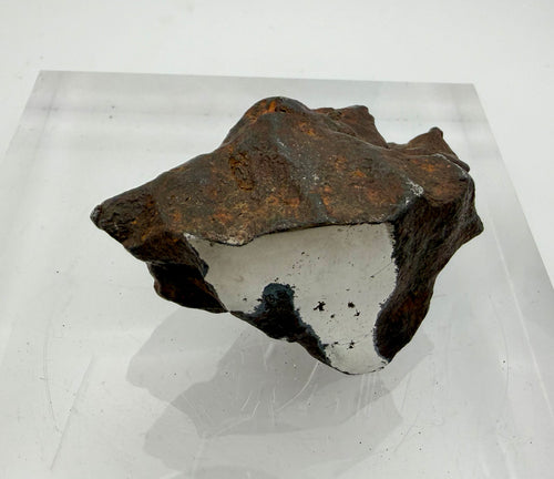 Gebel Kamil iron meteorite 216.06g -- polished face revealing uniform ataxite texture without Widmanstätten patterns
