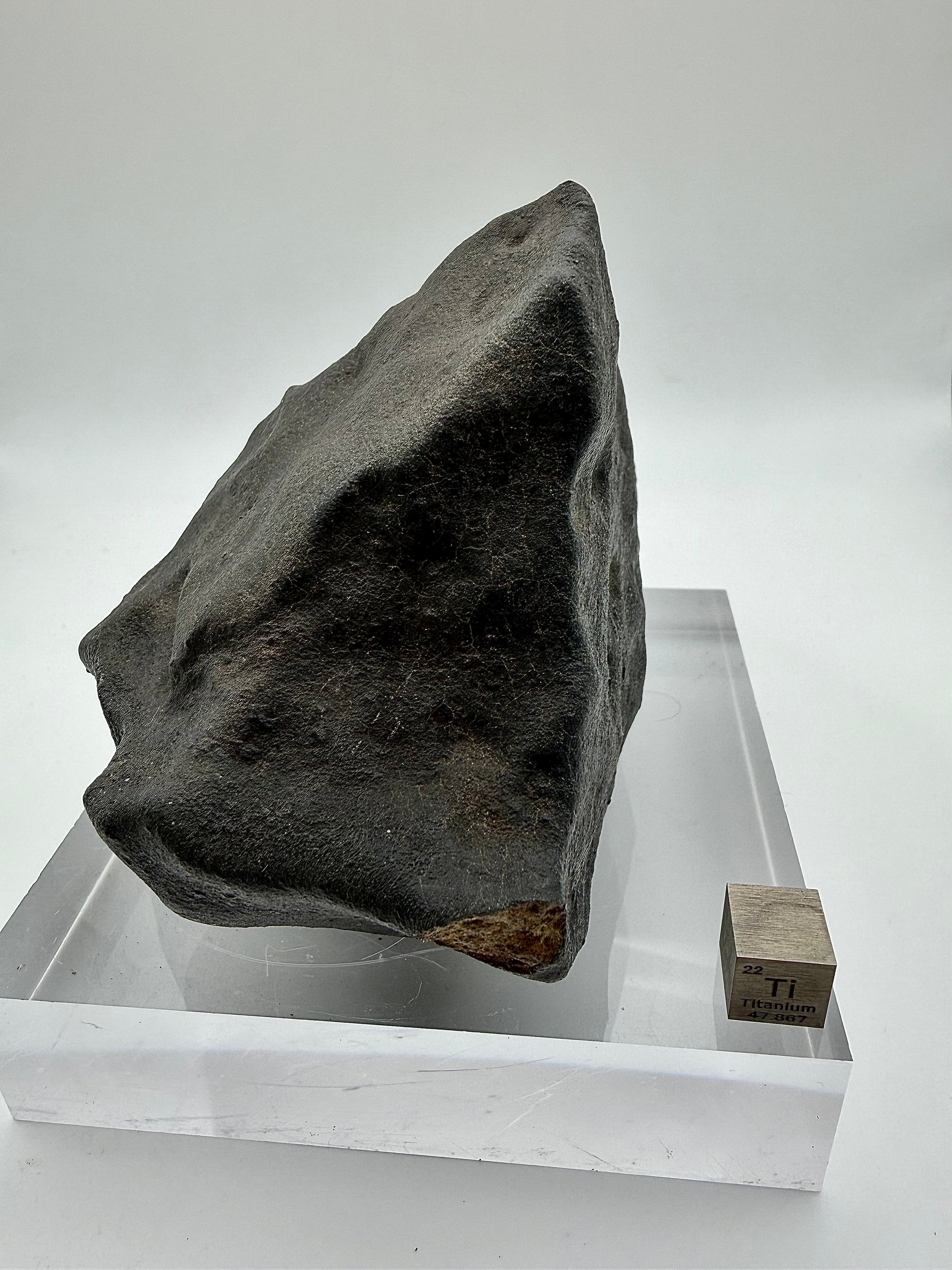 NWA XXX ordinary chondrite 820.15g -- flight-oriented profile showing wedge geometry and asymmetric crust distribution