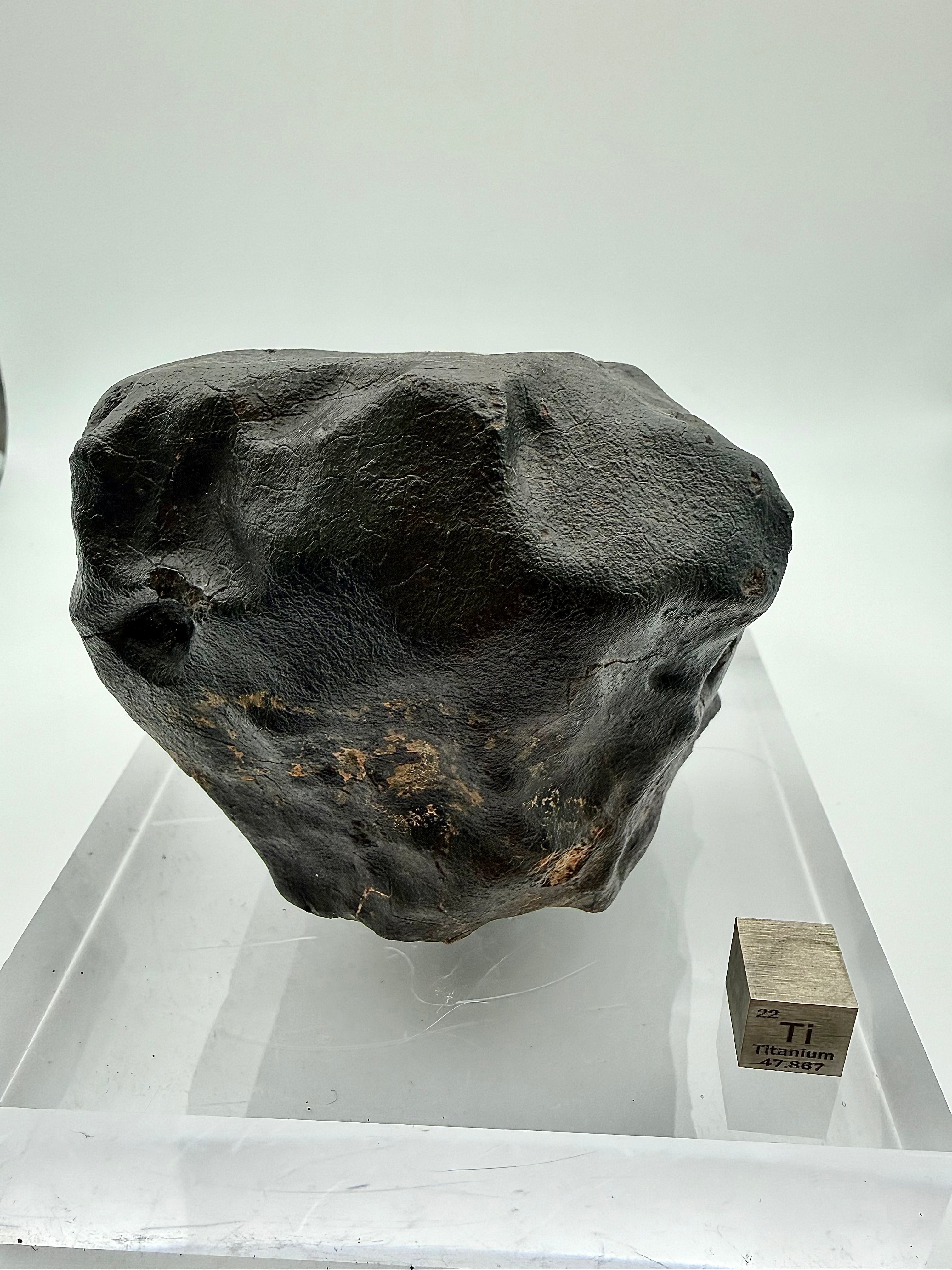 NWA XXX chondrite 635.58g -- forward-facing surface showing pronounced regmaglypts and thermal contraction cracks in fusion c