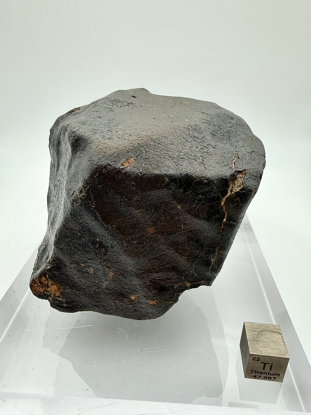NWA XXX chondrite 635.58g -- detail of regmaglypt depressions and secondary crust development along oriented surface