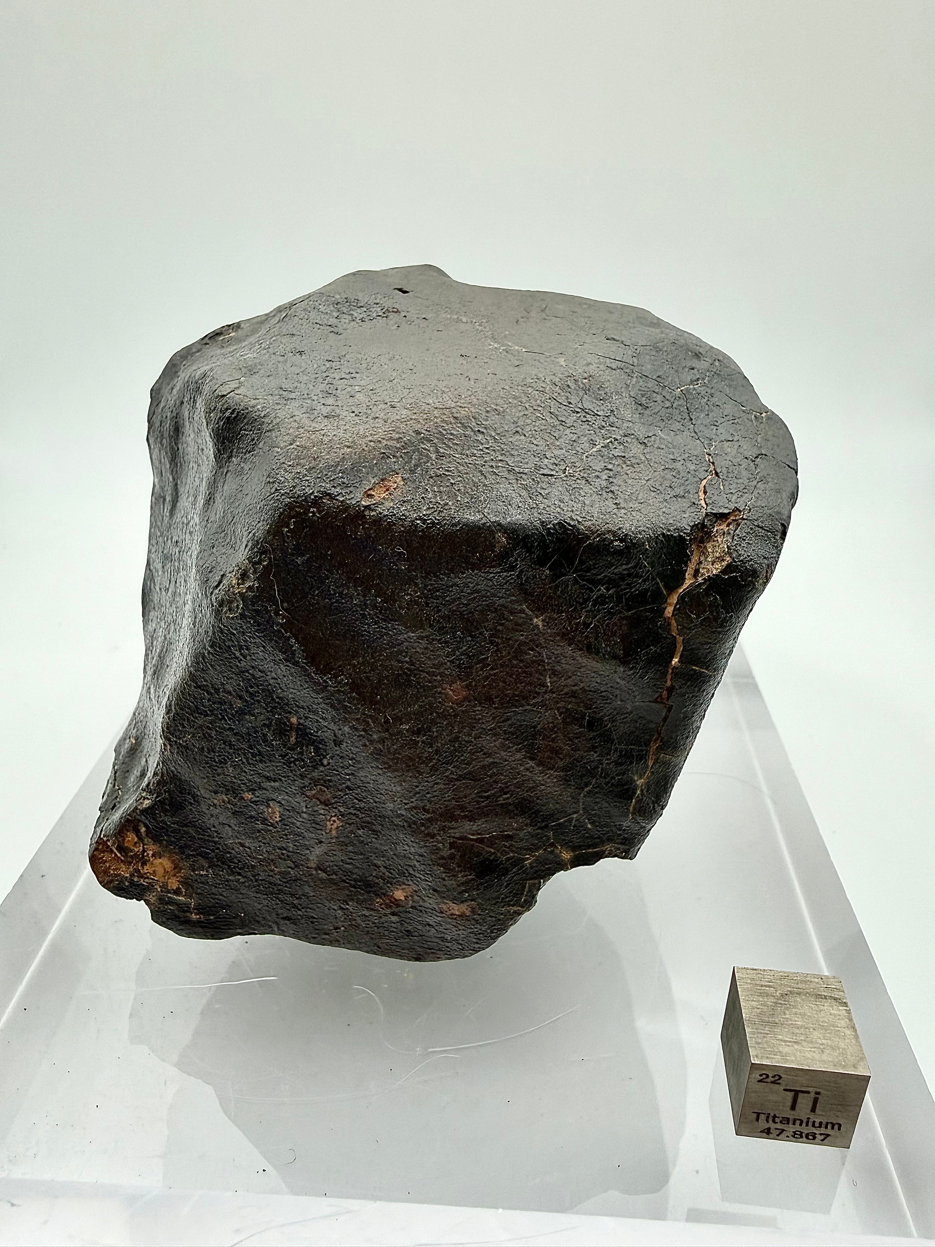 NWA XXX chondrite 635.58g -- detail of regmaglypt depressions and secondary crust development along oriented surface