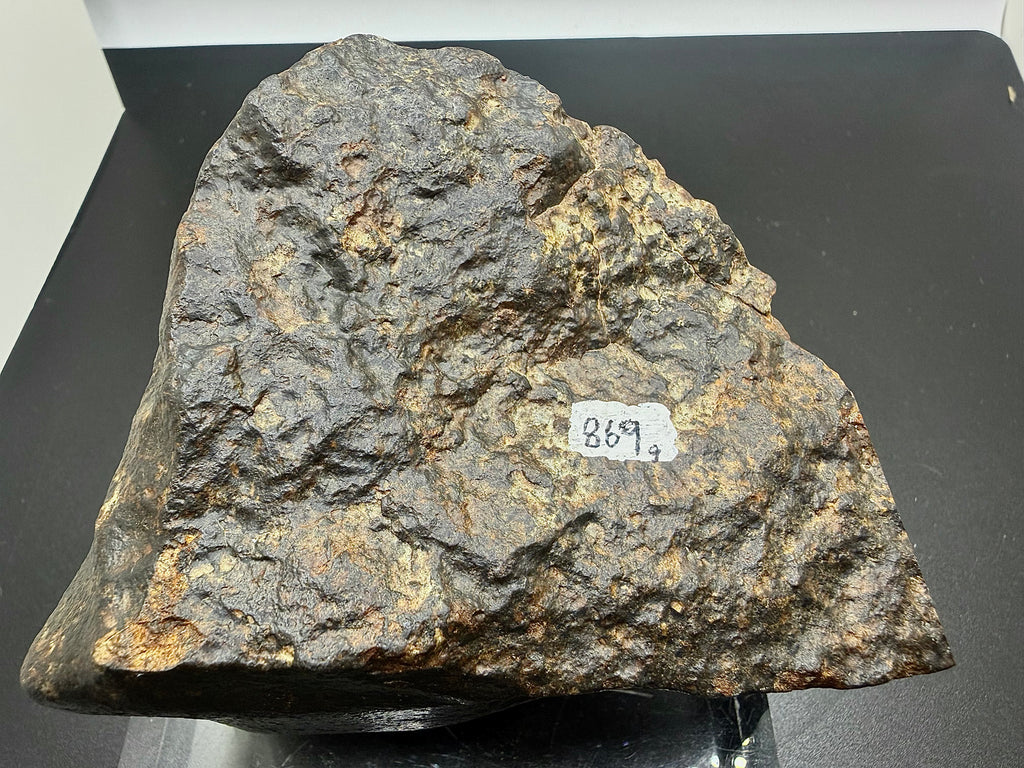 NWA XXX chondrite 869.00g -- regmaglypt depth variation across fusion-crusted surface