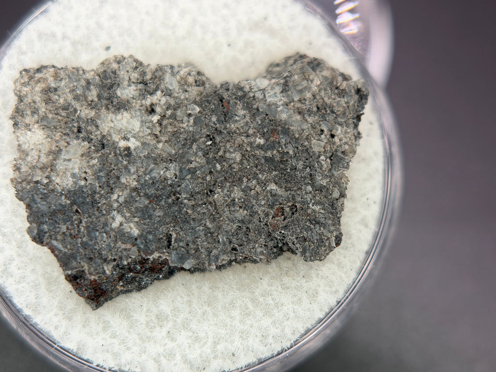 Ksar Ghilane 022 achondrite 2.11g -- equant augite grain texture with minor enstatite and sulfide phases visible on cut surfa