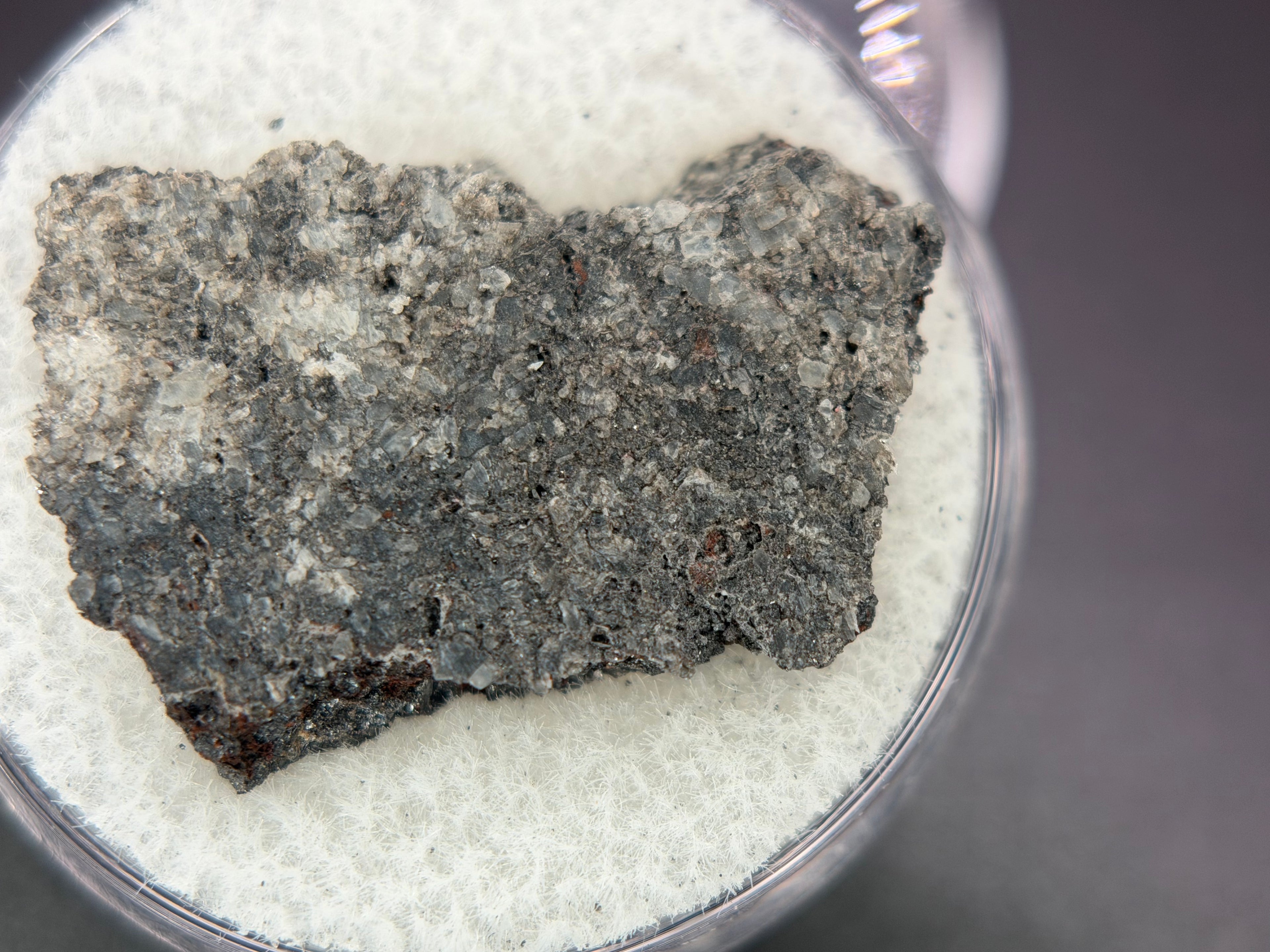 Ksar Ghilane 022 achondrite 2.11g -- equant augite grain texture with minor enstatite and sulfide phases visible on cut surfa