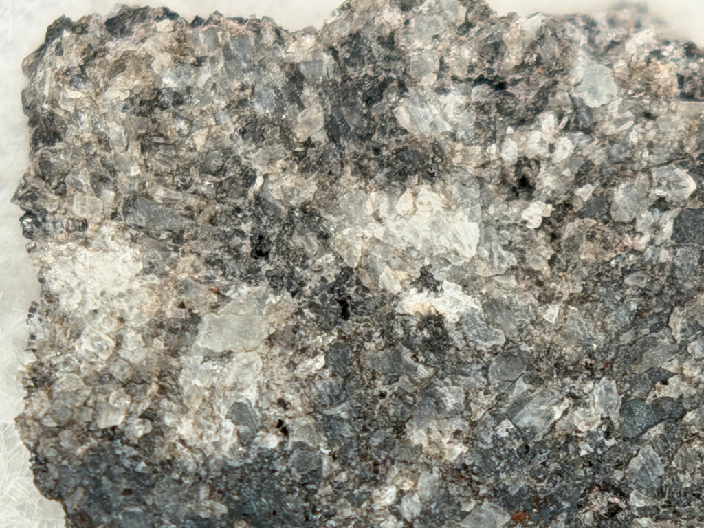 Ksar Ghilane 022 achondrite 2.11g -- calcite vein crosscutting augite-dominated igneous texture with accessory mineral phases