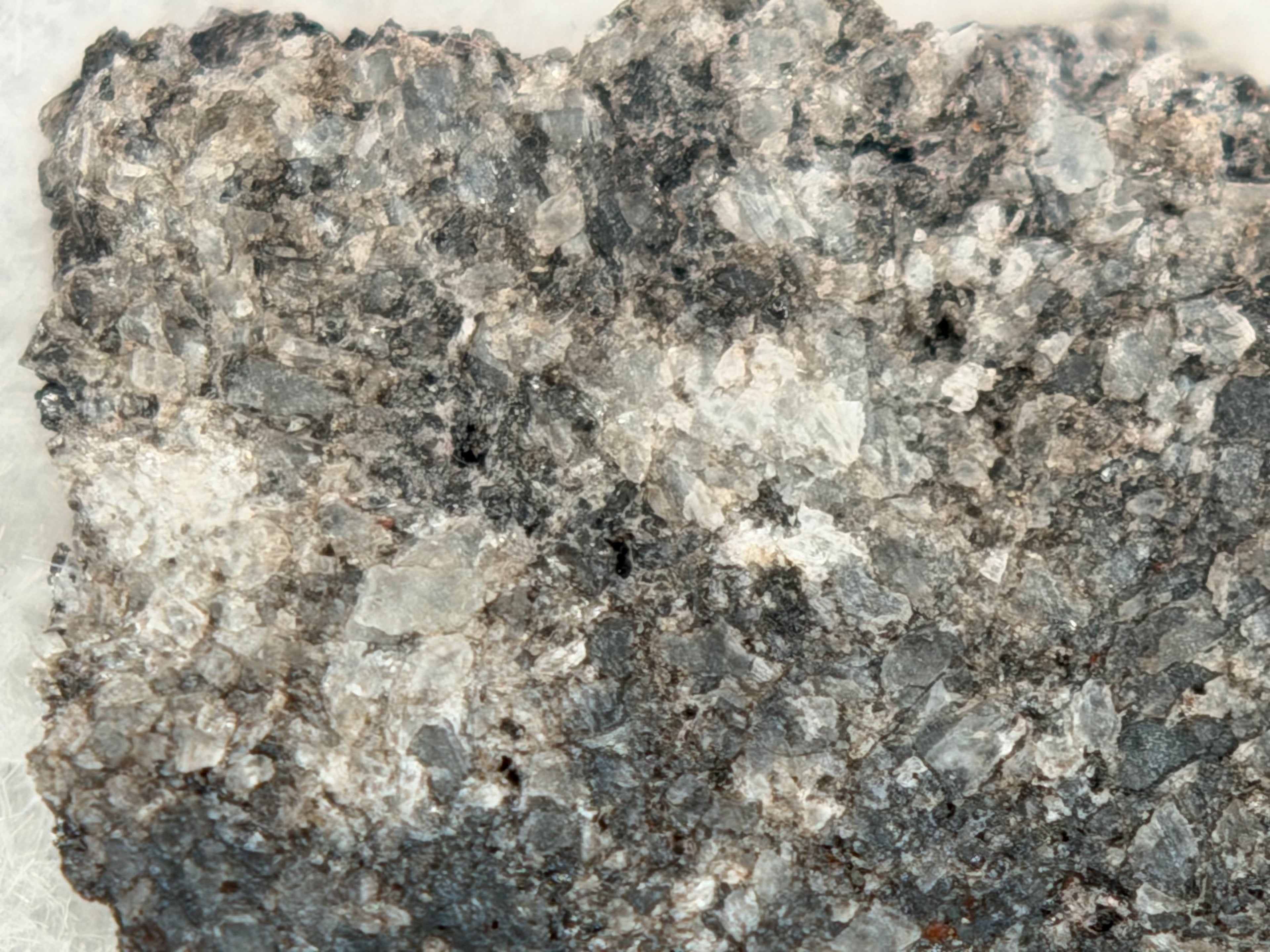 Ksar Ghilane 022 achondrite 2.11g -- calcite vein crosscutting augite-dominated igneous texture with accessory mineral phases