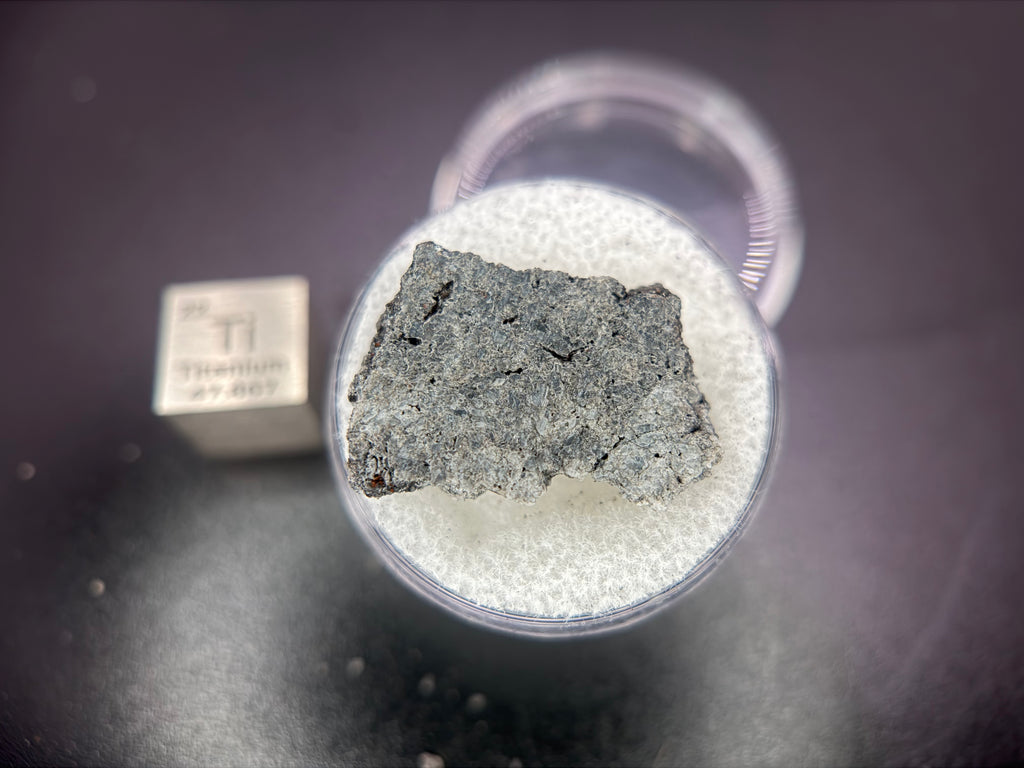 Ksar Ghilane 022 achondrite 2.11g -- full slice profile showing igneous texture and secondary alteration features under magni