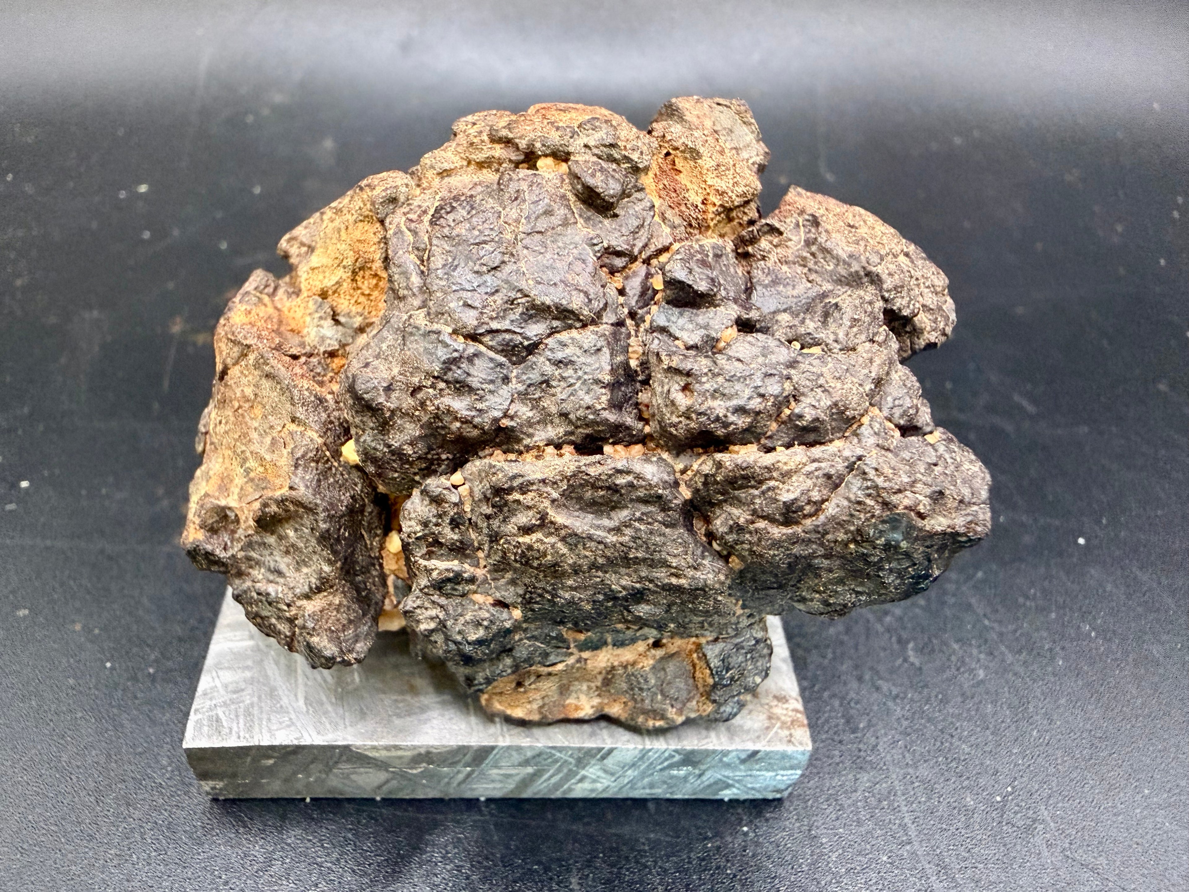Alternate front view of NWA 18592 Mesosiderite Meteorite showing fusion crust coverage and angular brecciated surface from above, 161g