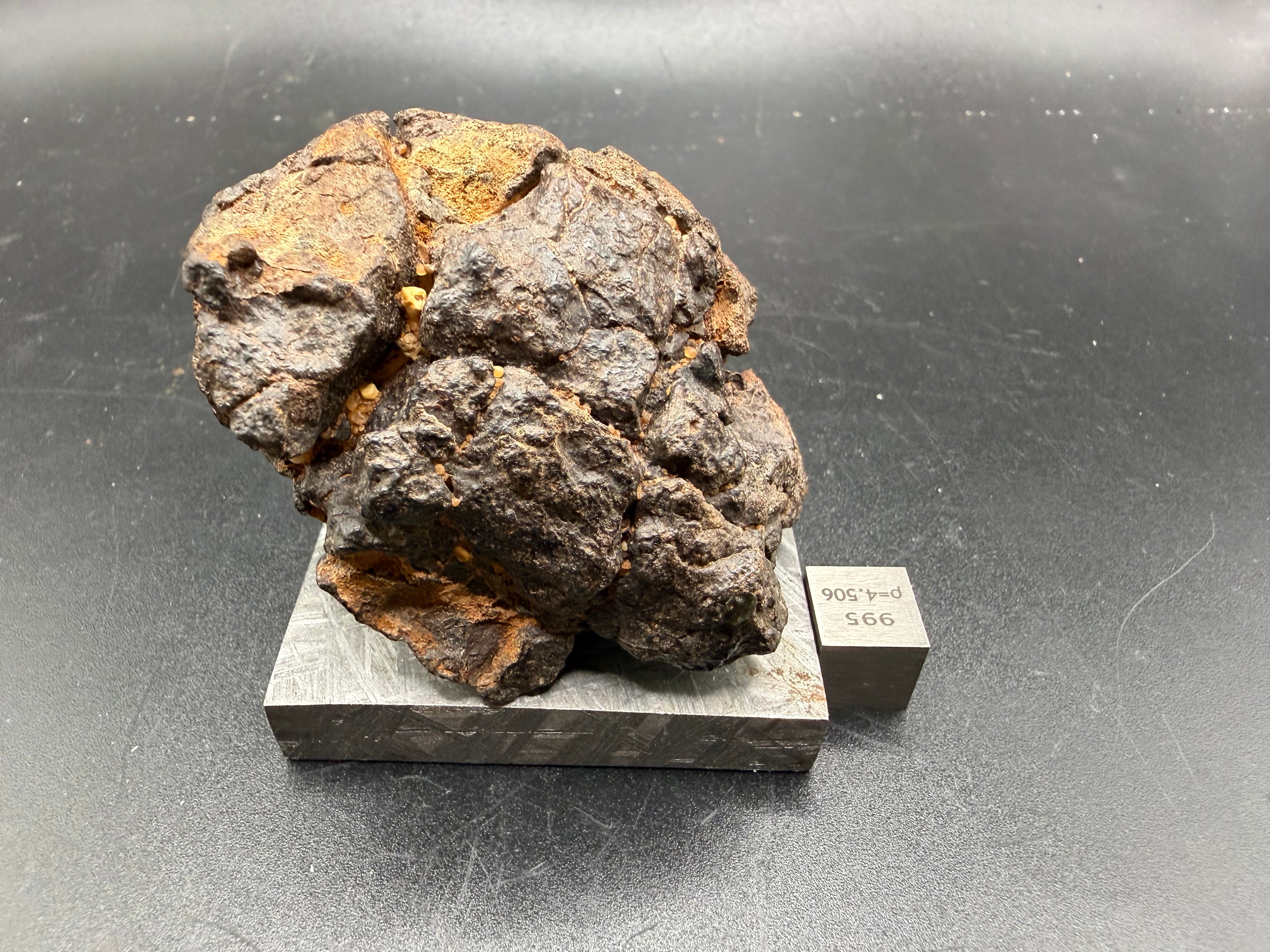 Full view of NWA 18592 Mesosiderite Meteorite on display stand showing complete individual with specimen identification label, 161g