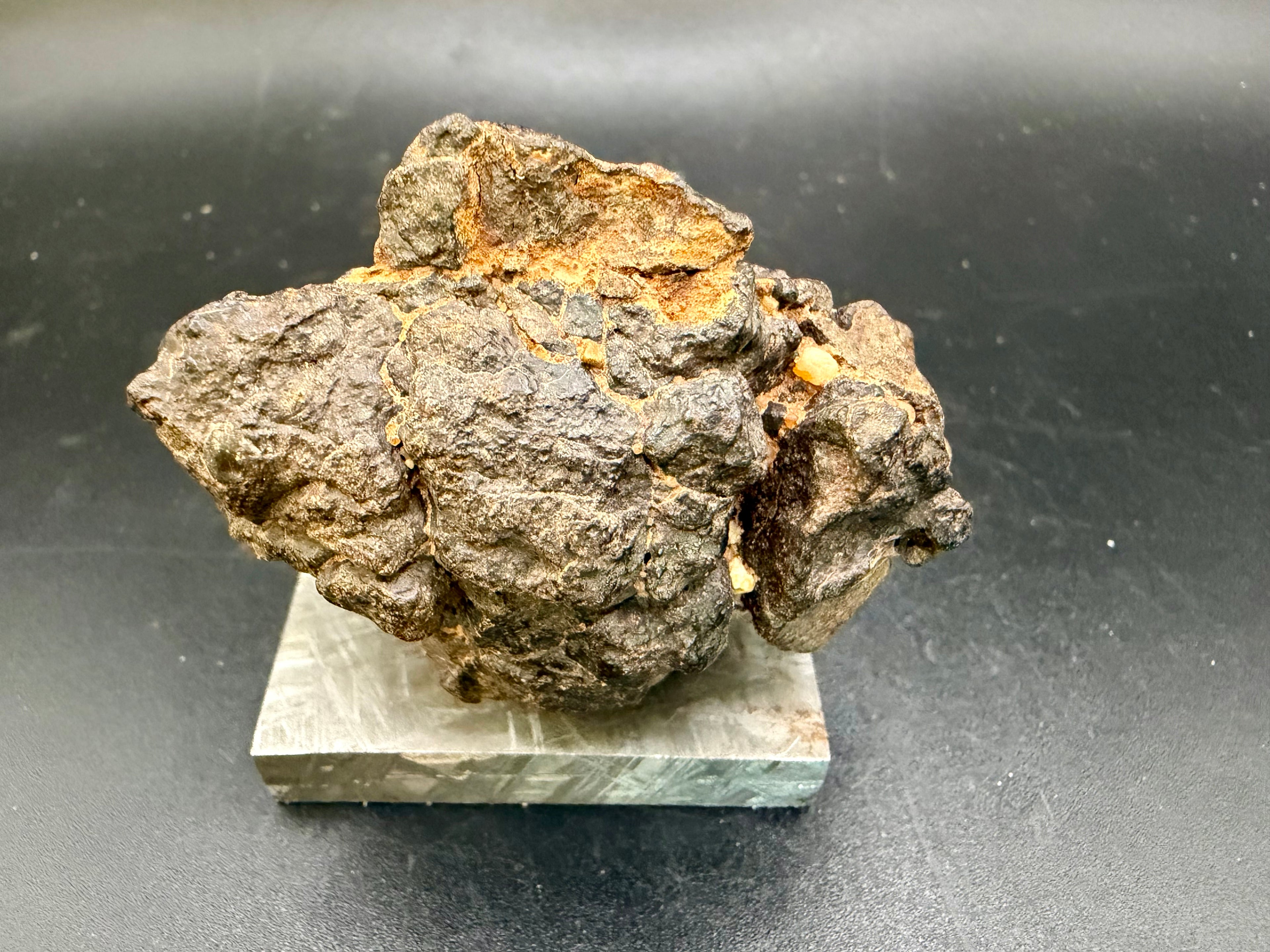 Side view of NWA 18592 Mesosiderite Meteorite showing complete individual profile with remnant fusion crust and irregular natural surface, 161g