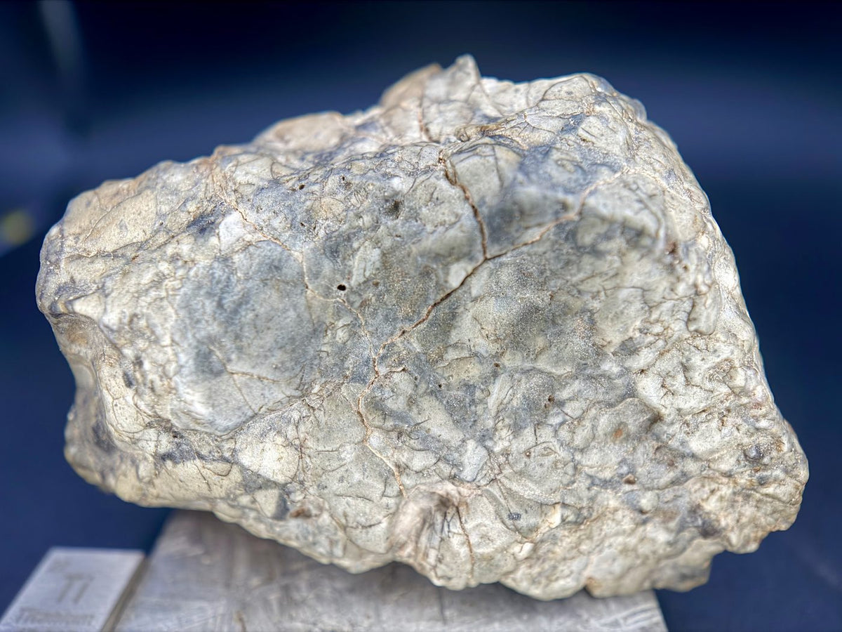 Close view of the Adrar 013 surface showing clast texture and a network of fine fractures