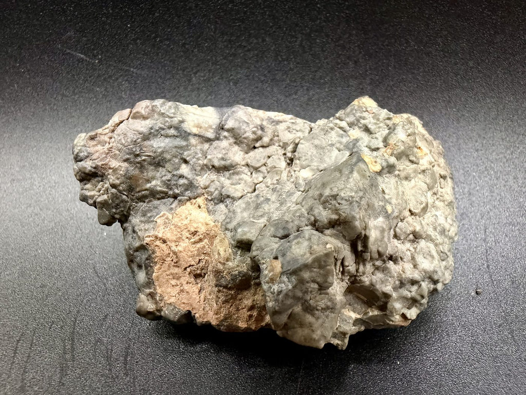 Reverse of the Adrar 013 stone with tan desert crust across part of the underside