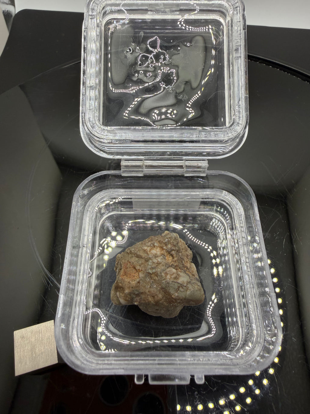 Adrar 013 Moon rock 10.53g in open display case showing anorthositic norite clasts suspended in recrystallized impact melt matrix