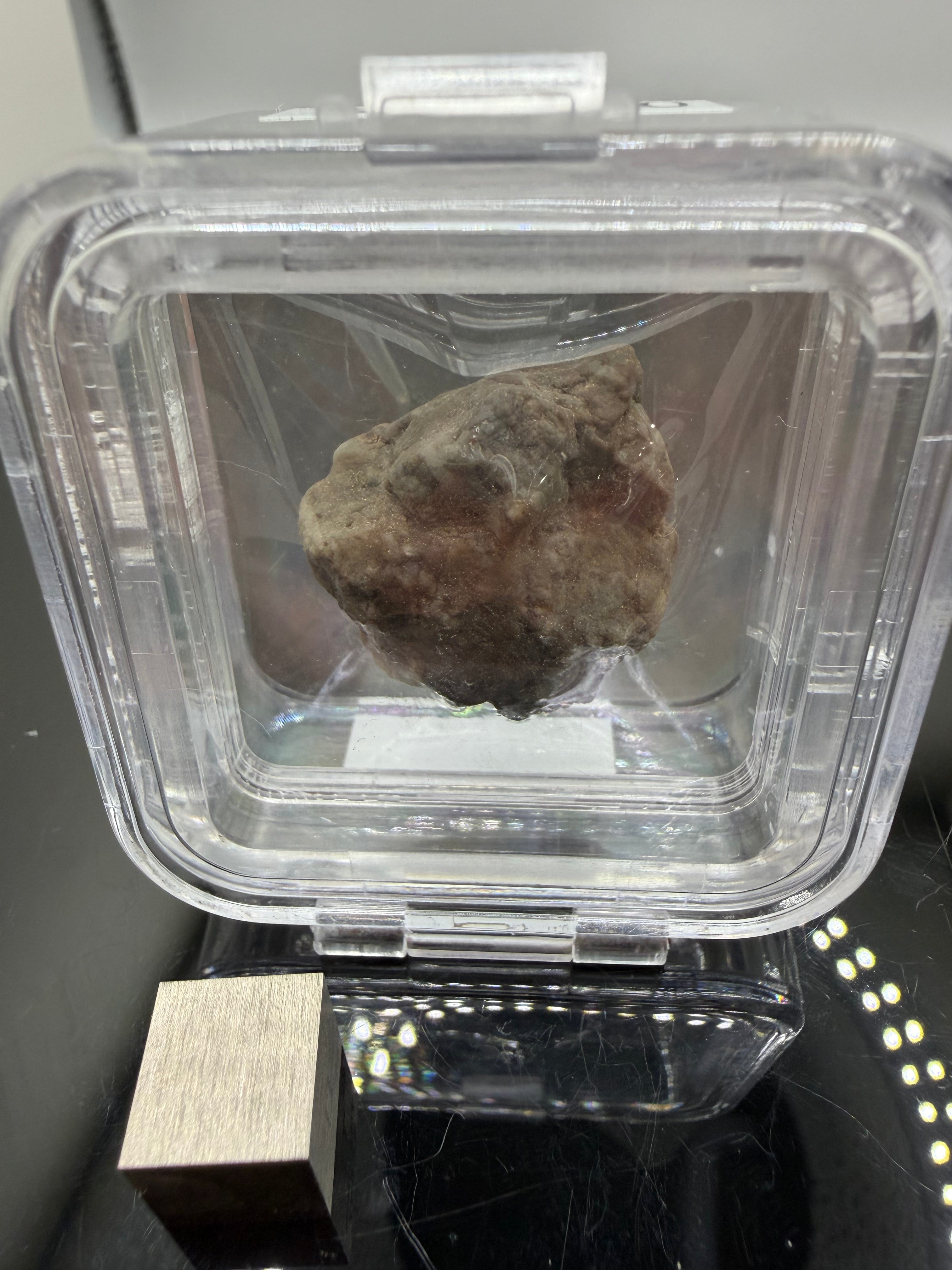 Adrar 013 lunar meteorite individual 10.53g complete uncut specimen in display case with metal scale cube showing three dimensional melt structure