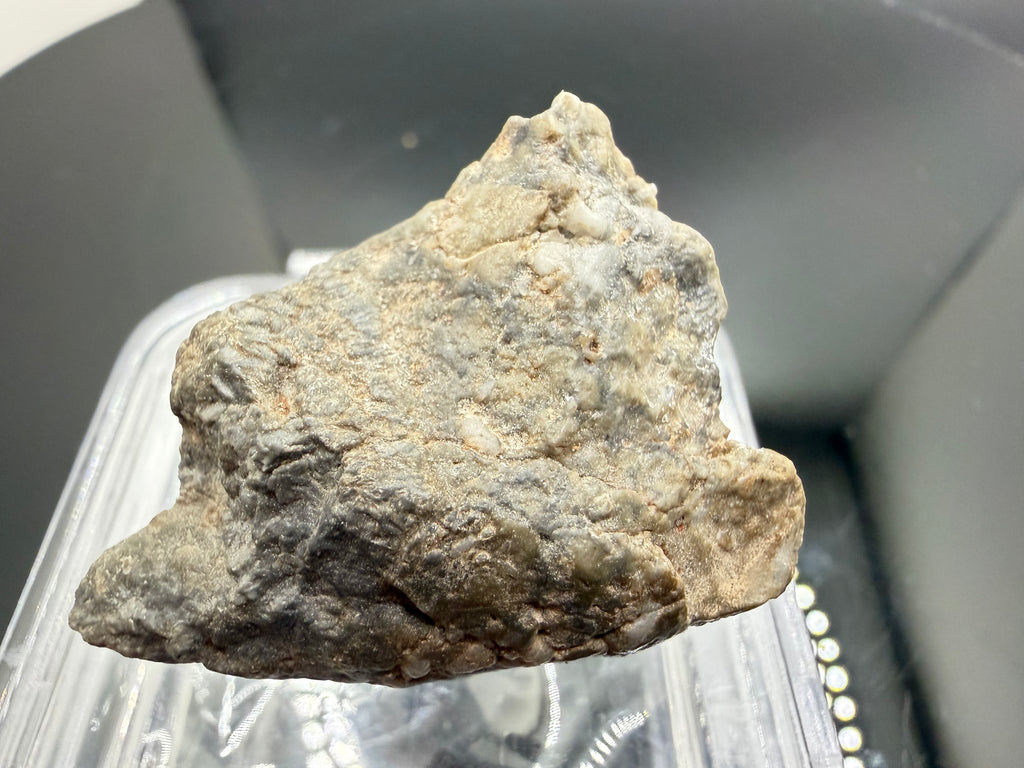 Adrar 013 lunar meteorite 14.76g showing angular lithic clasts surrounded by dark melt matrix