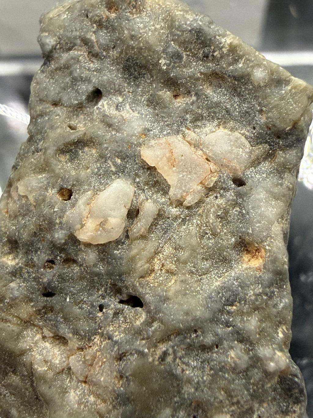 Adrar 013 lunar individual 8.08g macro surface texture showing rapid quench of impact generated melt with light colored mineral inclusions