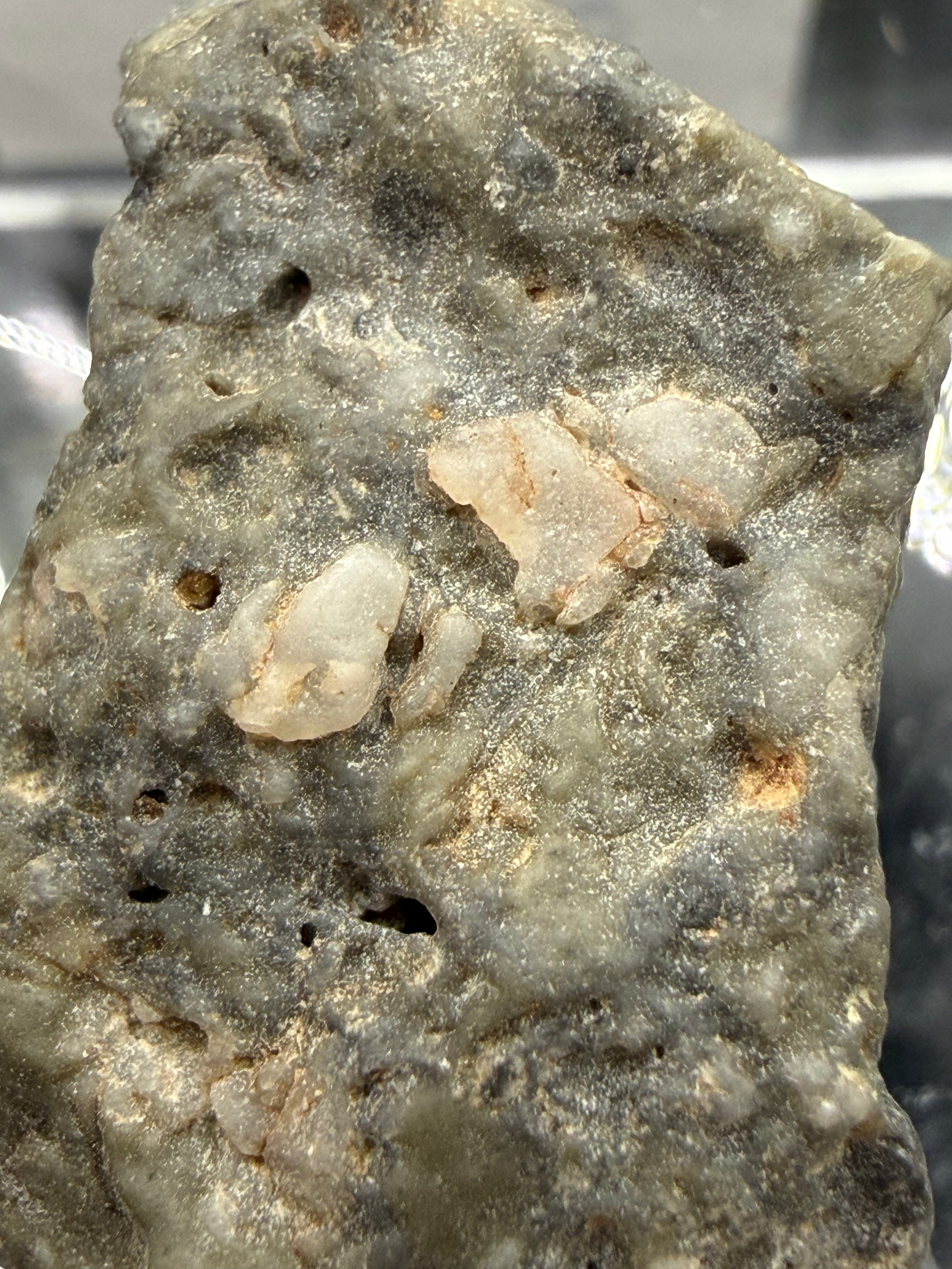 Adrar 013 lunar individual 8.08g macro surface texture showing rapid quench of impact generated melt with light colored mineral inclusions