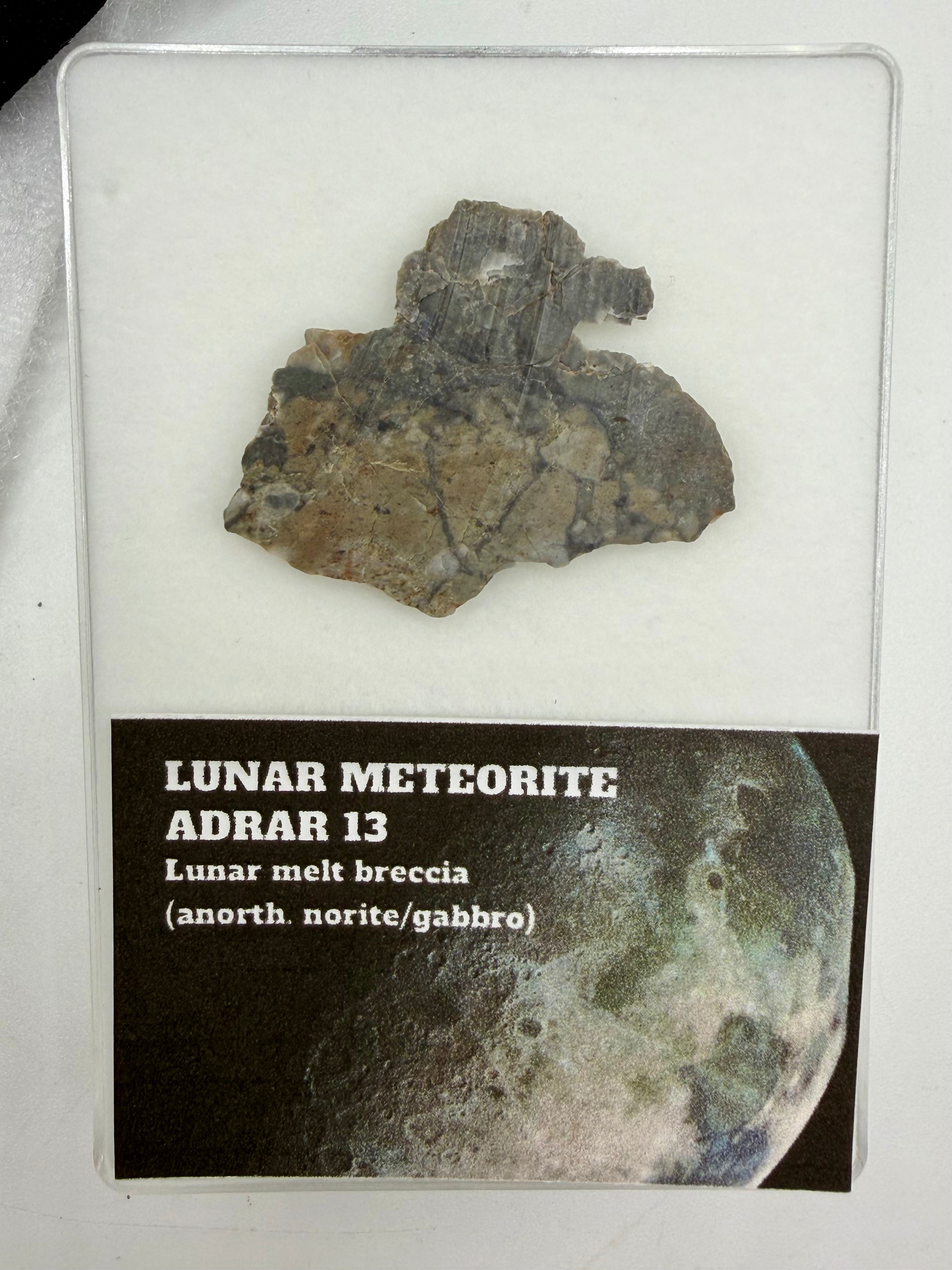 Adrar 013 lunar meteorite end cut, 4.39g, with display card showing classification