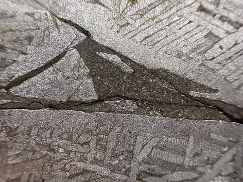 Detail of the etched Widmanstatten structure on the 161.49g Aletai iron meteorite slice with inclusion