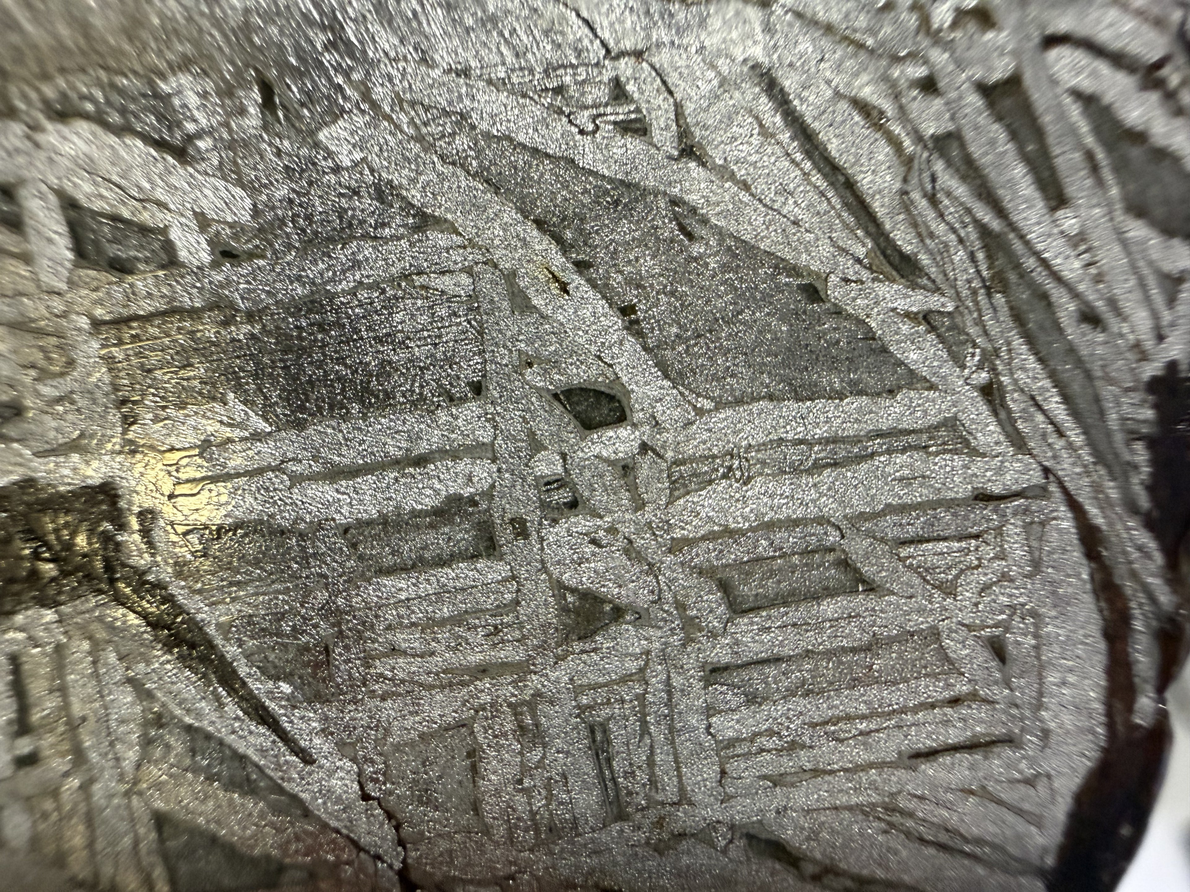 Macro of the Aletai iron meteorite, crosshatched Widmanstatten bands on the etched face