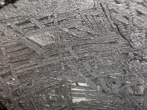 Close-up of the etched metal surface on the Aletai iron meteorite slice