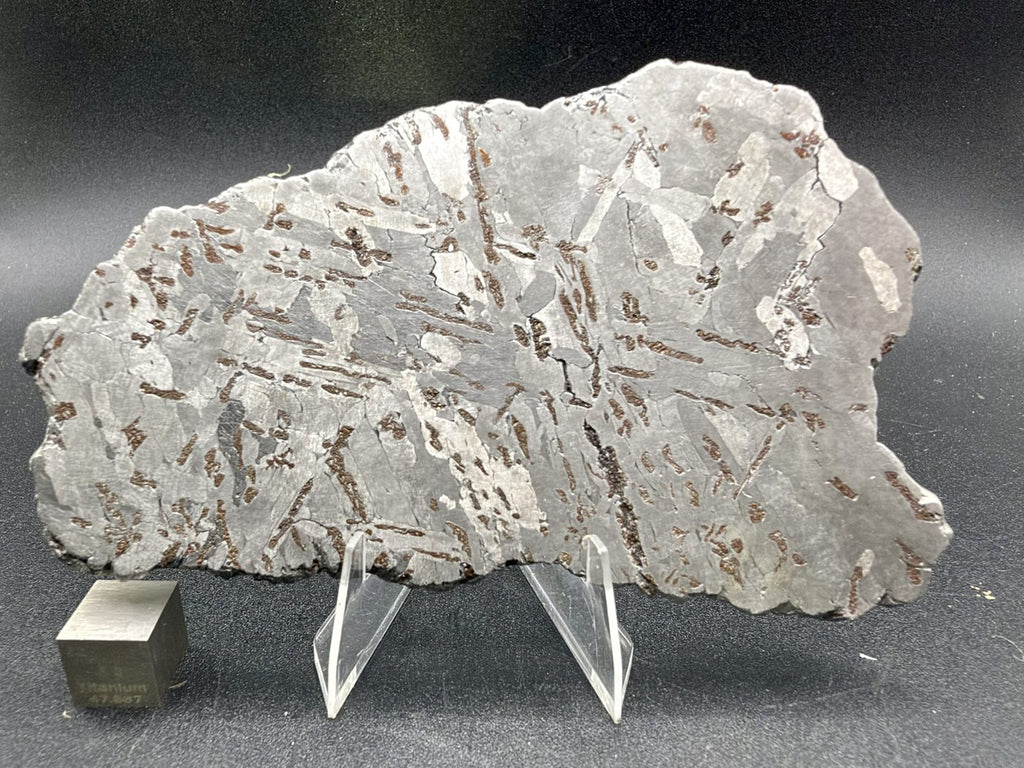 Canyon Diablo iron meteorite, IAB-MG, 112.54 g full slice on a clear acrylic stand with a scale cube, second etched face showing crossing kamacite plates and scattered bronze inclusions