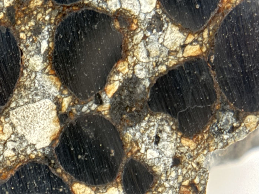 Close up of metal nodules and silicate fragments in Denader 004 CB chondrite