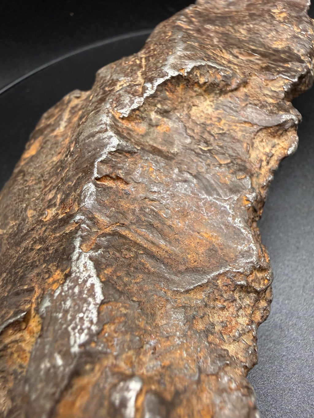Close-up of Gebel Kamil iron meteorite rollover lip where ductile metal folded during impact