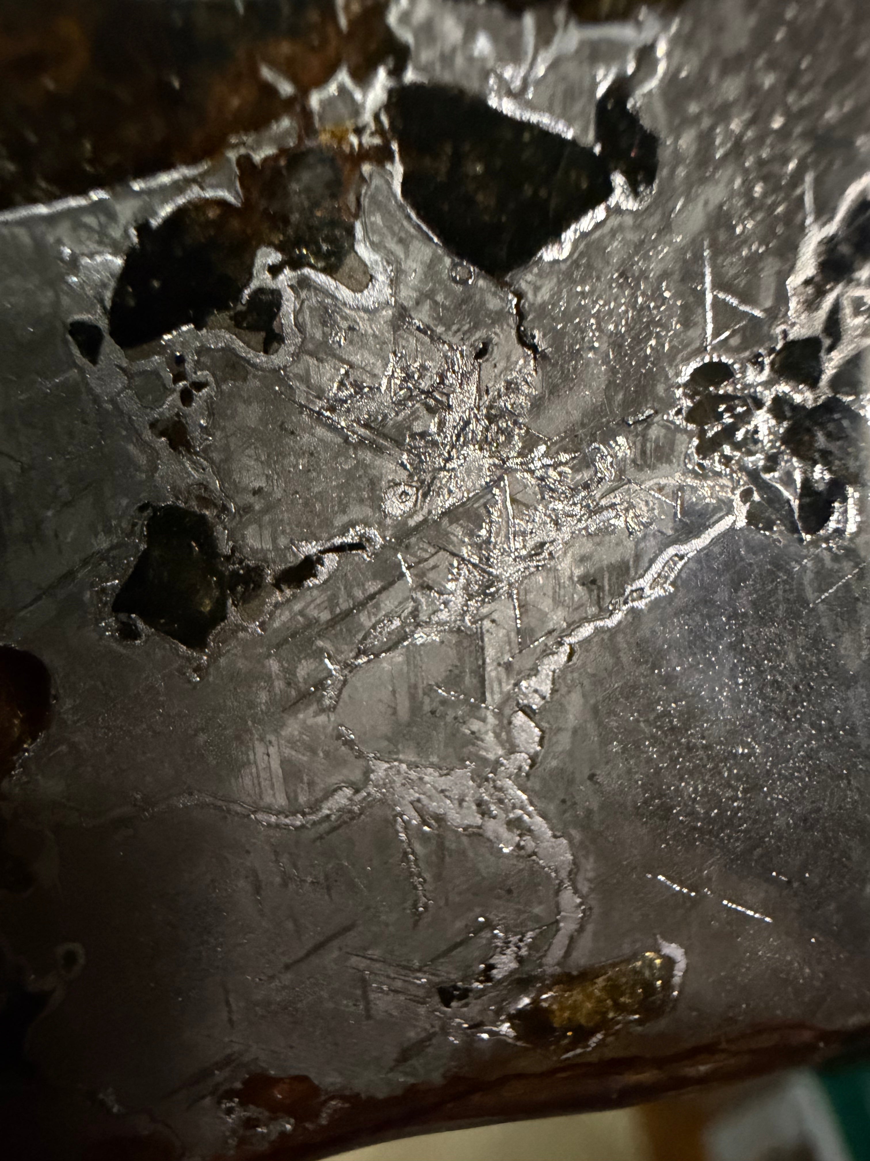 Macro detail of Gyarub Zangbo pallasite slice showing Widmanstatten crystal structure in iron-nickel matrix between olivine crystals, 54.18g