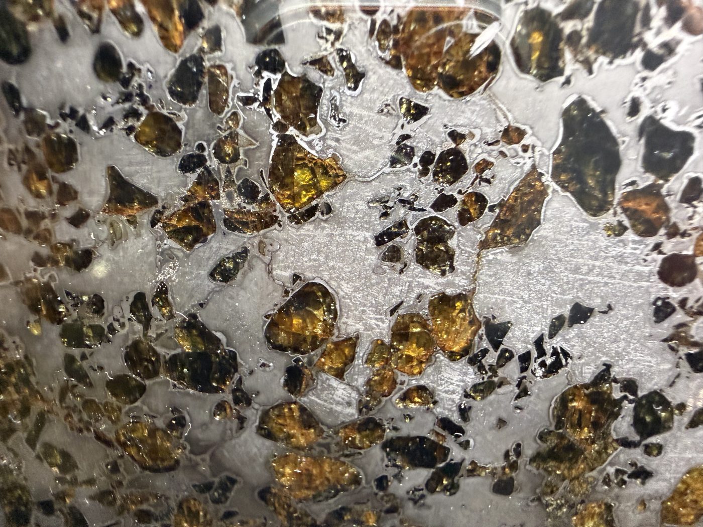Gyarub Zangbo ungrouped pallasite, 226.95g, macro detail of amber and gold olivine crystals in iron-nickel matrix