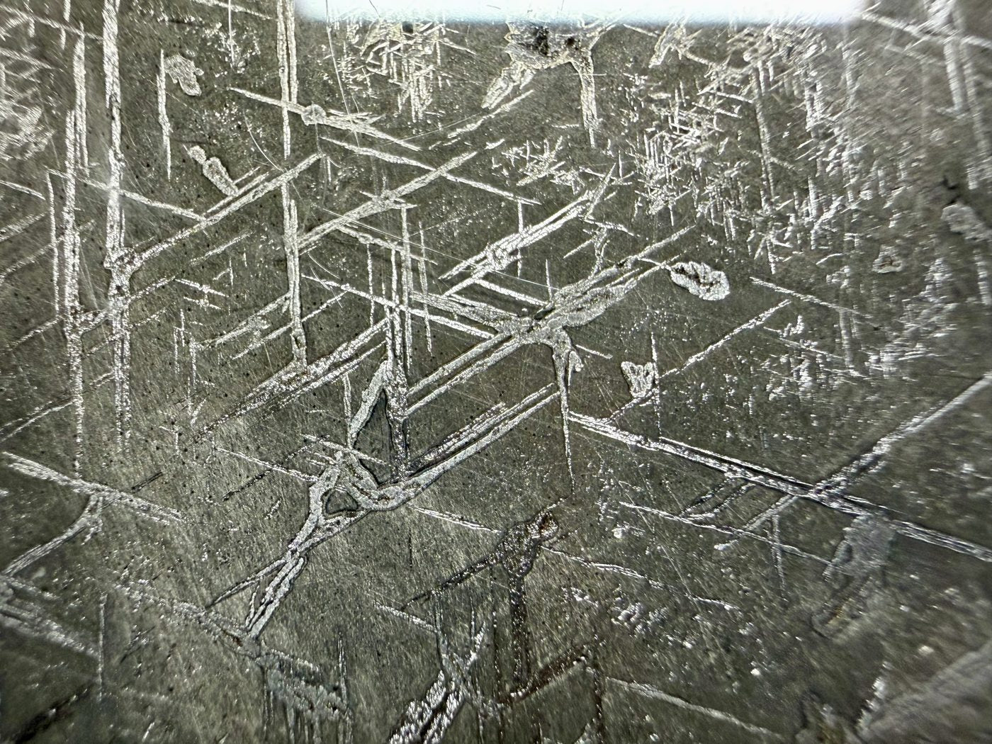 Macro view of Gyarub Zangbo pallasite showing the etched crosshatch pattern in the iron-nickel metal, 301.28g