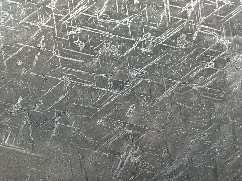 Macro view of fine crossing etch lines across Gyarub Zangbo pallasite metal, 324.46g